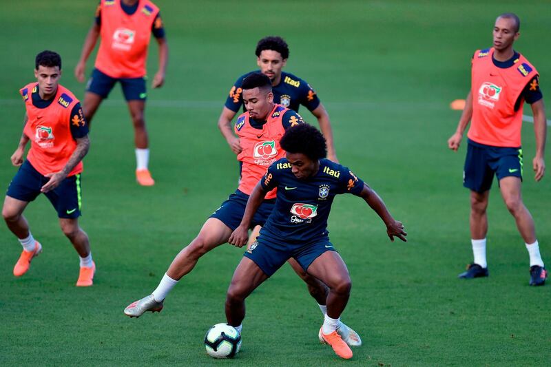 Brazil winger Willian shields the ball from Gabriel Jesus during a practice match. AFP