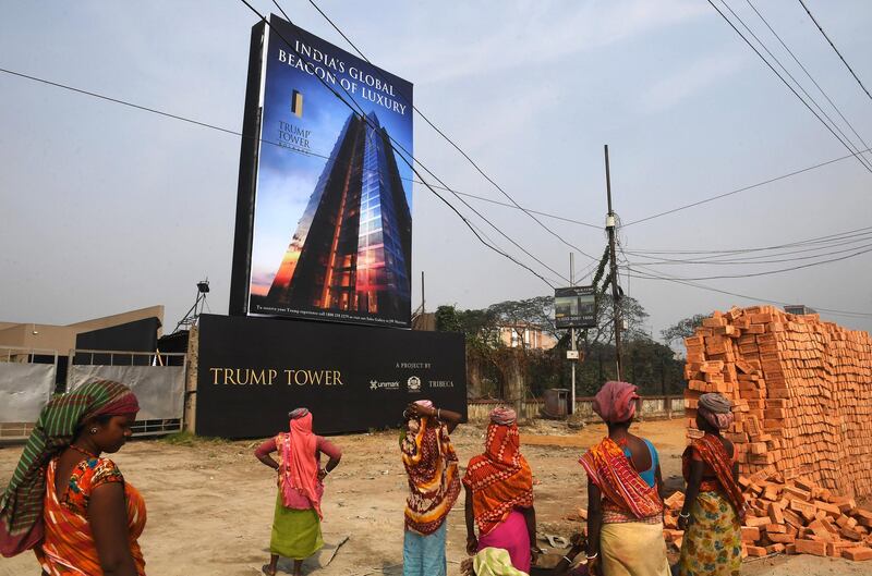 Indian labourers work on the road leading to the under-construction Trump Tower in Kolkata on February 20, 2018. 

Dozens of property investors and their families will be treated to dinner with Donald Trump junior in New Delhi this week after snapping up flats in a Trump Towers luxury development on the outskirts of the Indian capital, as the son of the US President Donald Trump visits development sites for real estate properties in cities across India.
 / AFP PHOTO / Dibyangshu SARKAR