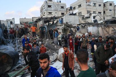 Palestinians stand in the aftermath of an Israeli bombardment in Rafah, Gaza. A charity said it had got aid through to one of the city's hospitals. AFP