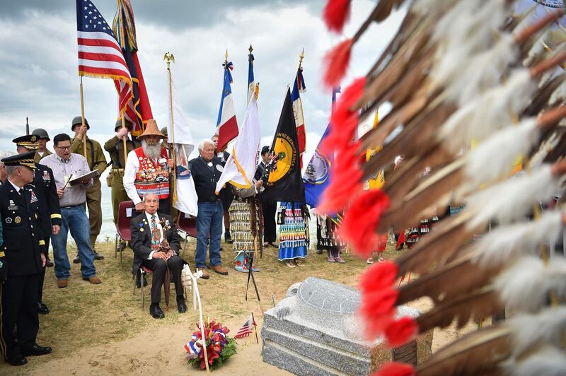 WWII US native American Indian veteran Charles Shay takes part with others in a ceremony on Omaha Beach in Saint-Laurent-sur-Mer, western France. AFP