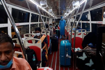Indian citizens evacuated from Dubai by Air India flight, board a shuttle bus to quarantine centres from Anna International Airport as part of a massive repatriation effort due to the COVID-19 coronavirus pandemic, in Chennai on May 9, 2020. The first wave of a massive exercise to repatriate hundreds of thousands of Indians stuck abroad began May 7, with two flights landing in India from the United Arab Emirates. / AFP / Arun SANKAR                        
