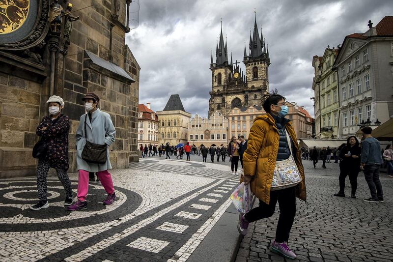 PRAGUE, CZECH REPUBLIC - MARCH 12: Tourists wearing face masks are seen at the Old Town Square on March 12, 2020 in Prague, Czech Republic. The government of the Czech Republic has declared a 30-day state of emergency due to the coronavirus outbreak. Czech Ministry of Health confirmed several dozens cases of COVID -19 on March 12, 2020 in the Czech Republic. (Photo by Gabriel Kuchta/Getty Images)