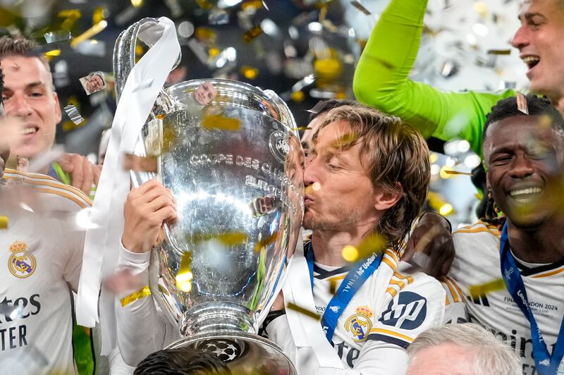 Real Madrid midfielder Luka Modric kisses the trophy after winning the Champions League for the sixth time in his career. AP