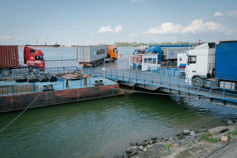 Trucks board a ferry over the Danube to Ukraine.  Bloomberg