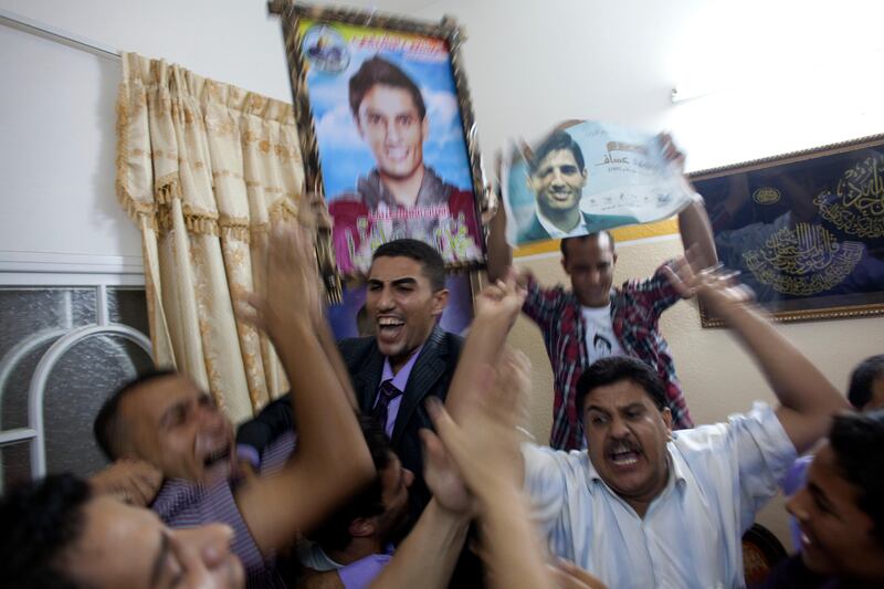 Shadi Assaf (middle) the brother of Mohammed Assaf react with joy  with other family members and friends at the family home in a refugee camp  Khan Younis, Gaza , as  Mohammed Assaf is announced the winner of the  regional 'Arab Idol' singing contest held in Beirut , Lebanon June 22,2013.Thousands of Palestinians in Gaza and the West Bank took to the streets to celebrate his victory. (Photo by Heidi Levine/Sipa Press). *** Local Caption ***  IMG_0461.jpg