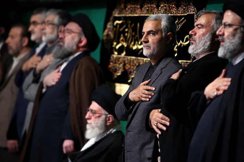 (FILES) In this file handout photo released on March 27, 2015 by the official website of the Centre for Preserving and Publishing the Works of Iran's supreme leader Ayatollah Ali Khamenei, shows him (C) with the commander of the Iranian Revolutionary Guard's Quds Force, Gen. Qasem Soleimani (3rd from R), attending a religious ceremony in Tehran to commemorate the anniversary of the death of the daughter of Prophet Mohammed. Top Iranian commander Qasem Soleimani was killed in a US strike on Baghdad's international airport on January 3, 2020, Iraq's powerful Hashed al-Shaabi paramilitary force has said, in a dramatic escalation of tensions between Washington and Tehran. / AFP / KHAMENEI.IR / HO
