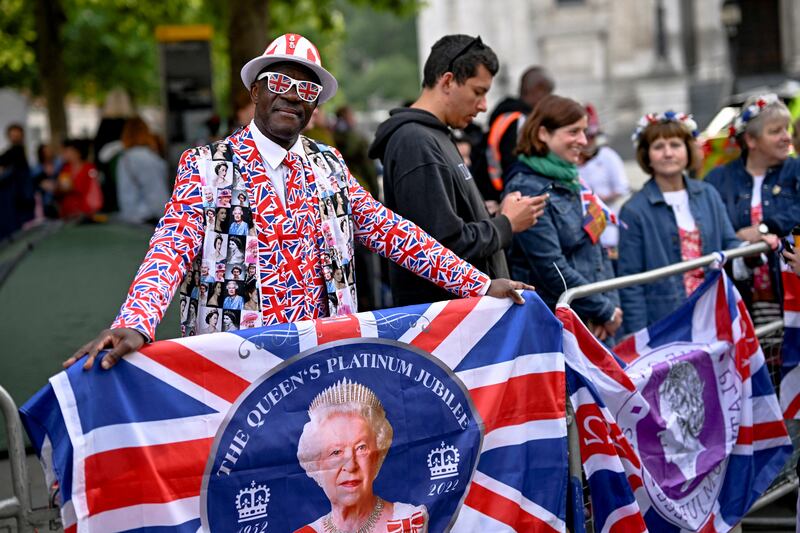 A man in costume enjoys the day outside St Paul's Cathedral before the service of thanksgiving, part of celebrations marking the queen's platinum jubilee, in London. Reuters
