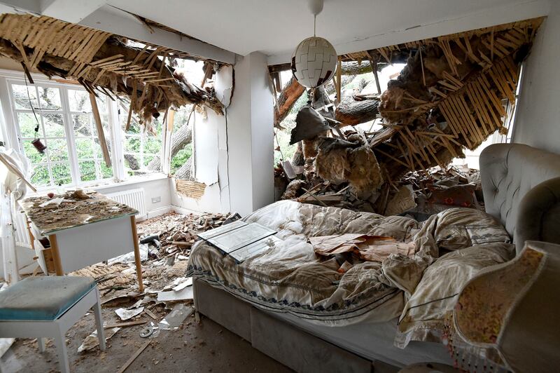 Debris is seen in a bedroom at the home of Dominic Good, a day after a 400-year-old oak tree in the garden was uprooted by Storm Eunice, in Stondon Massey, near Brentwood, Essex, England. AP