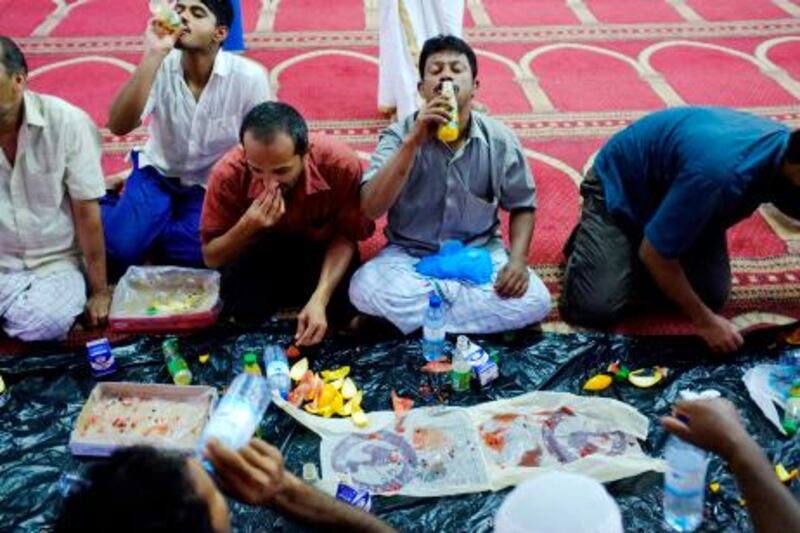 August 27. Worshippers break their fast with a simple Iftar meal at the Hakim Ibn Hizam mosque in Mina Zayed (Port Zayed). August 27, Abu Dhabi. United Arab Emirates (Photo: Antonie Robertson/The National)