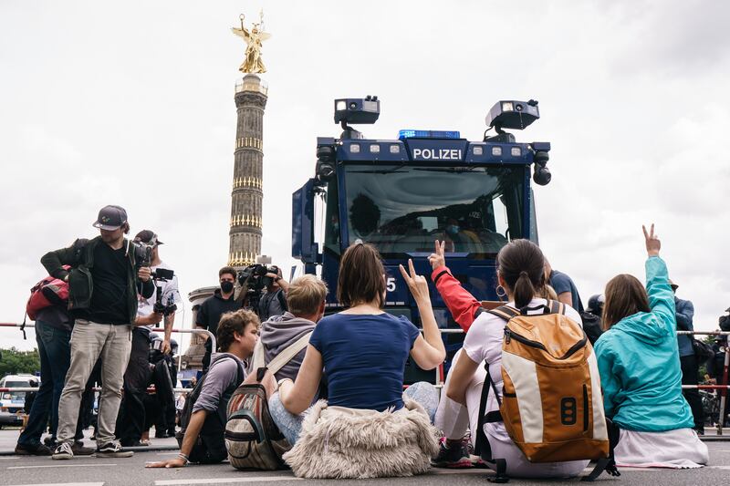 Protesters in front of a water cannon near the Victory Column as they try to join an unauthorised protest organised by the Querdenken 711 group in Berlin. Demonstrations were held despite Berlin police banning all protests against measures imposed to curb the spread of the coronavirus.