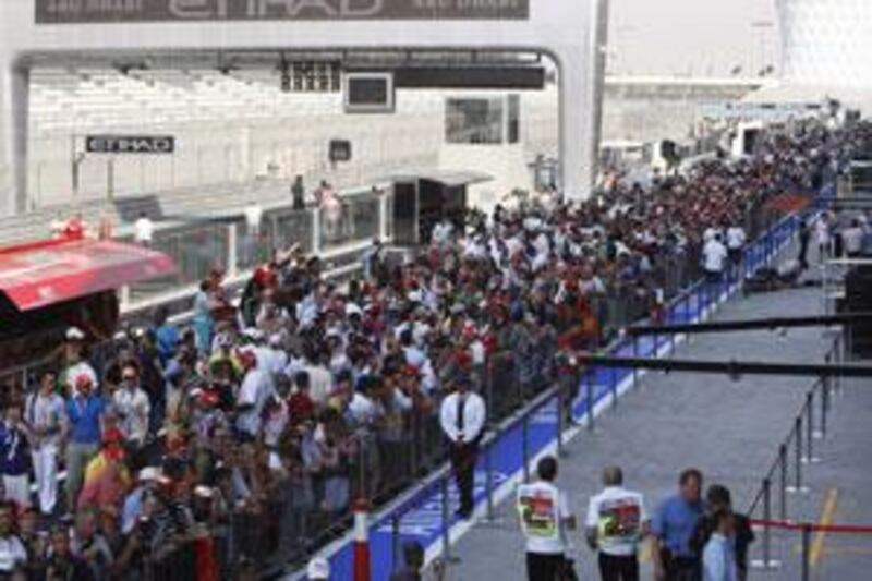 Fans pack into the pit lane during the first chance for ticket holders to see the track.