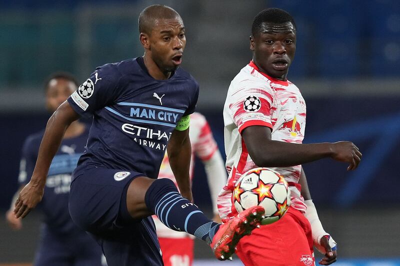 Leipzig's Dutch forward Brian Brobbey and Manchester City's Brazilian midfielder Fernandinho vie for the ball during the UEFA Champions League, Group A, match in Leipzig, eastern Germany on December 7, 2021. AFP