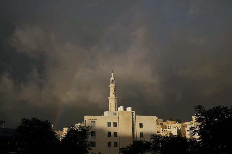 A rainbow is seen over a closed mosque during the first day of Eid Al Fitr after the government imposed a full lockdown in Amman, Jordan. Reuters