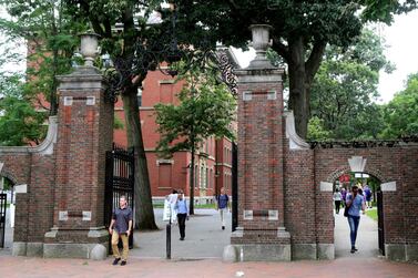 In this 2019 photo, pedestrians walk through the gates of Harvard Yard at Harvard University in Cambridge, Massachusetts. AP Photo
