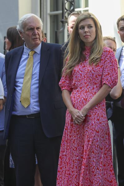 Carrie Symonds, partner of Boris Johnson, U.K. prime minister, right, stands outside number 11 Downing Street in London, U.K., on Wednesday, July 24, 2019. British business is wasting no time in urging Johnson to avoid crashing out of the European Union.  Photographer: Simon Dawson/Bloomberg