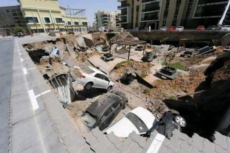 A huge concrete slab between three tower blocks of the development plunged one floor down into an underground car park. Courtesy of Al Ittihad