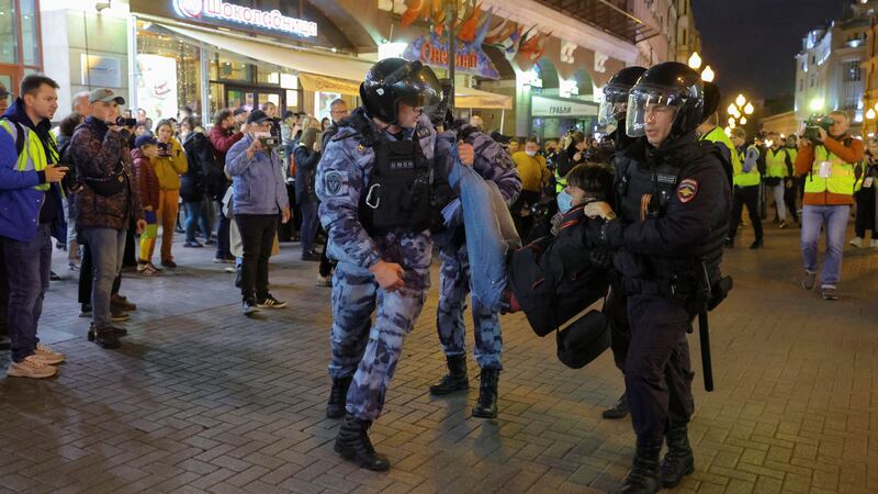 Russian law enforcement officers detain a person during an unsanctioned rally after opposition activists called for street protests against the mobilisation. Reuters