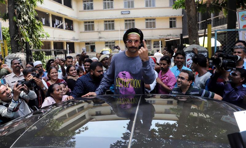 Ranveer Singh poses for photographs as he leaves a polling station after casting his vote in Mumbai on April 29, 2019. AFP