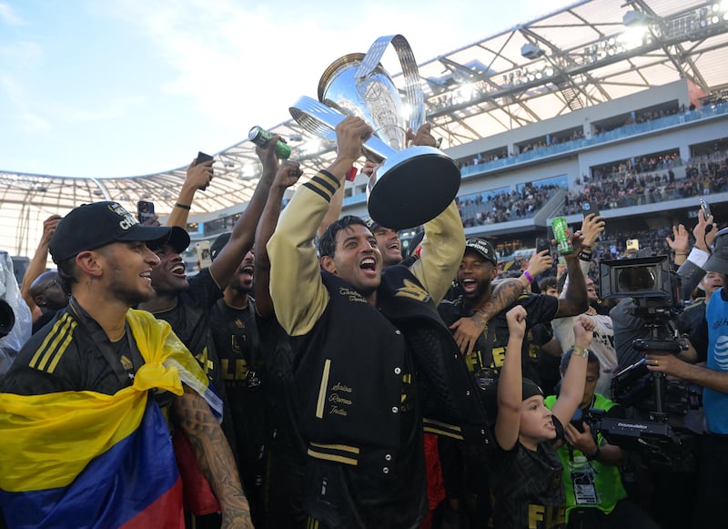 Los Angeles FC forward Carlos Vela celebrates with the Philip F Anschutz Trophy. USA Today