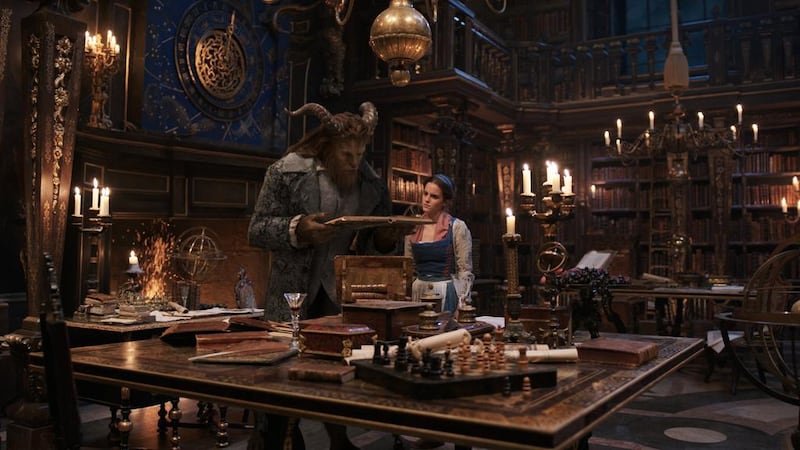 The Beast (Dan Stevens) and Belle (Emma Watson) in the castle library in Beauty and the Beast, a remake of Disney’s 1991 animated fairy tale classic. Courtesy Disney.