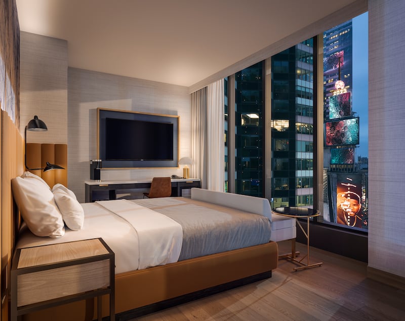 All rooms have floor-to-ceiling windows so guests can watch the entertainment of Times Square without leaving their suite. Photo: LL Holdings /  Hilton