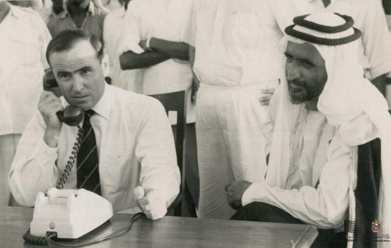 Watched by Sheikh Rashid, the British political resident, Donald Hawley, inaugurates Dubai's telephone service on July 29, 1960. Lady Ruth Hawley