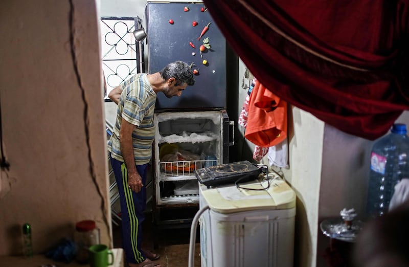 A Lebanese man looks at his empty refrigerator at his apartment in the capital. AFP