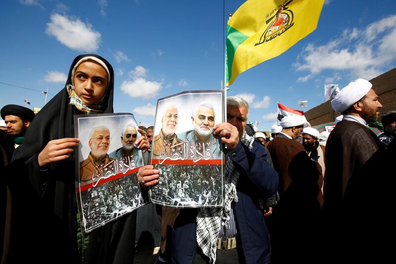 Iranian people carry pictures of the late Iran's Quds Force top commander Qassem Soleimani and Iraqi militia commander Abu Mahdi al-Muhandis, who were killed in a U.S. airstrike at Baghdad airport, during the forty days memorial at the "Valley of Peace" cemetery in Najaf, Iraq February 11, 2020. REUTERS/Alaa al-Marjani