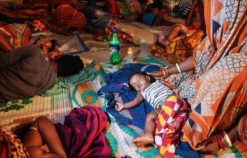 People rest in a cyclone relief shelter in Puri in the eastern Indian state of Odisha as cyclone Fani approaches the Indian coastline. AFP