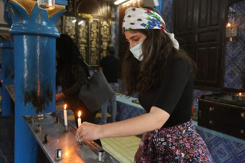 A Tunisian Jewish pilgrim lights a candle on the first day of the annual pilgrimage to the Ghriba Synagogue, the oldest Jewish monument built in Africa, in the Mediterranean Tunisian resort island of Djerba. AFP