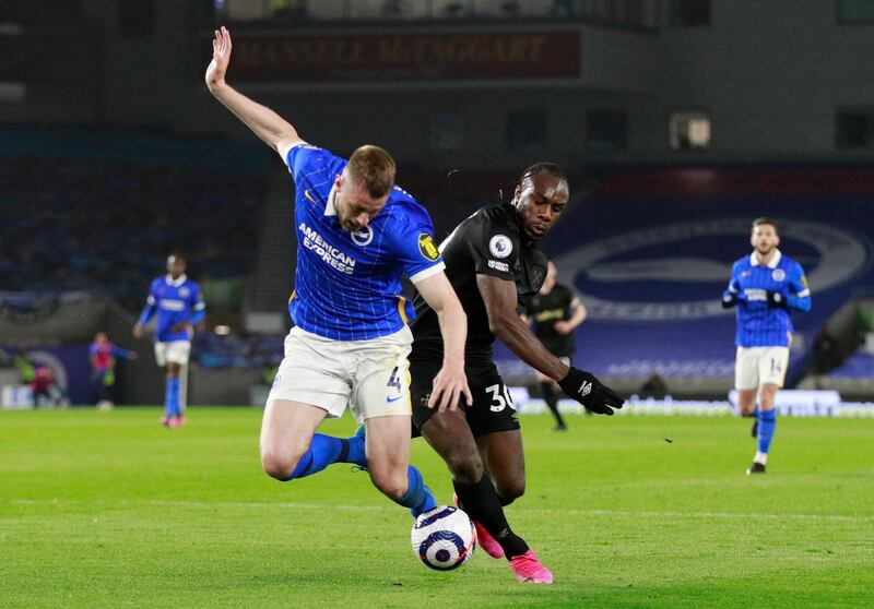 Brighton's Adam Webster in action with West Ham United's Michail Antonio. Reuters