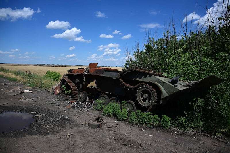 An Ukrainian infantry fighting vehicle lies by the roadside, having been destroyed by Russian forces in Ukraine.  AFP