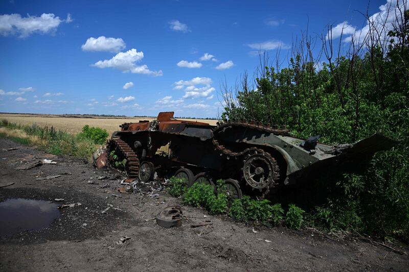 An Ukrainian infantry fighting vehicle lies by the roadside, having been destroyed by Russian forces in Ukraine.  AFP