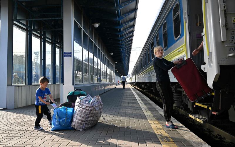 A mother and child who fled Ukraine arrive back in Kyiv from Poland. The daily number returning has exceeded those leaving for the first time since the February invasion. AFP   
