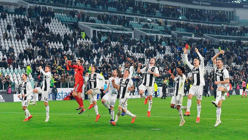 Juventus players celebrate in front of fans after beating SPAL. AP Photo