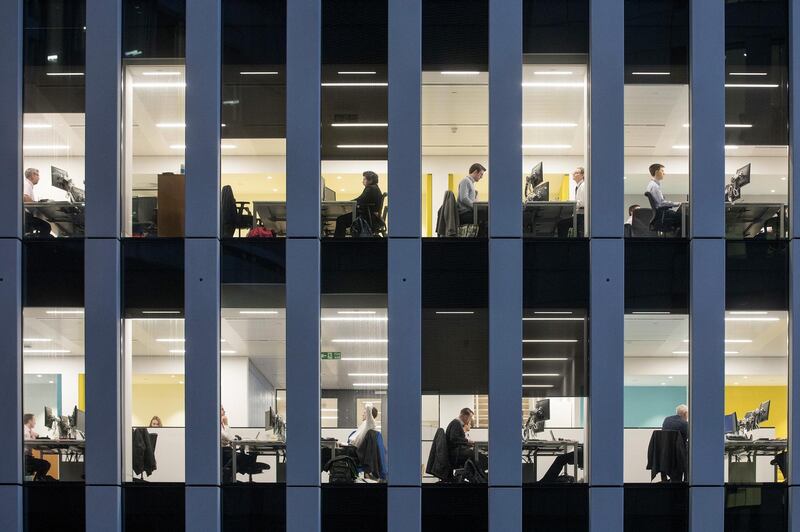 Office workers sit inside an illuminated office building, U.K., on Thursday, Nov. 22, 2018. Brexit Britain will be the top destination for major European investors to snap up commercial property next year, according to a survey of executives managing more than 500 billion pounds ($640 billion) of real estate conducted by Knight Frank. Photographer: Chris Ratcliffe/Bloomberg