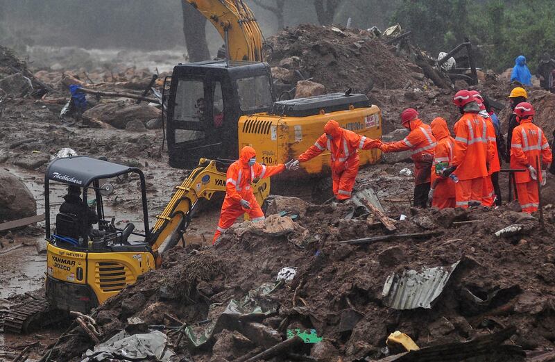 Rescue workers look for survivors at the site of a landslide during heavy rains in Idukki, Kerala. Reuters