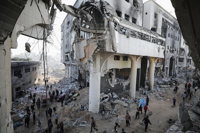 Palestinians inspect the damage at Al Shifa Hospital, which was left in ruins. Reuters