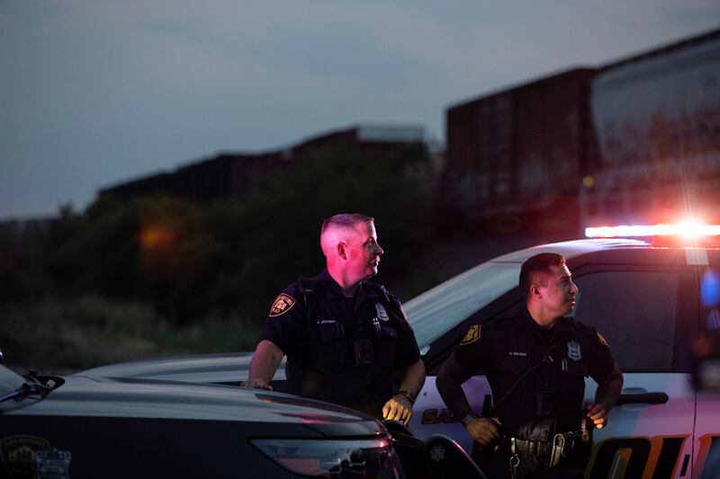 Law enforcement officers at the deadly scene. Reuters