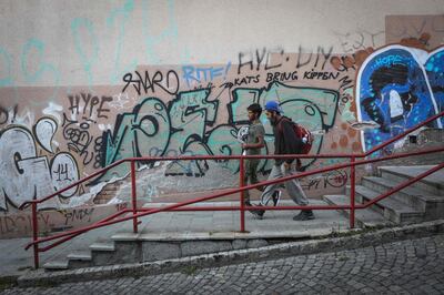 A group of migrants walk in downtown Belgrade, on August 19, 2020.  Although the so-called Balkan route was officially closed after the peak of Europe's migrant crisis five years ago, the region is seeing a fresh tide of travellers, even amid the coronavirus pandemic. Some 30,000 refugees and migrants were registered in Serbia in first half of 2020, almost three times the same period last year, according to official data.  Among them, 1,200 are minors travelling alone, the youngest at just seven years old. / AFP / Oliver BUNIC
