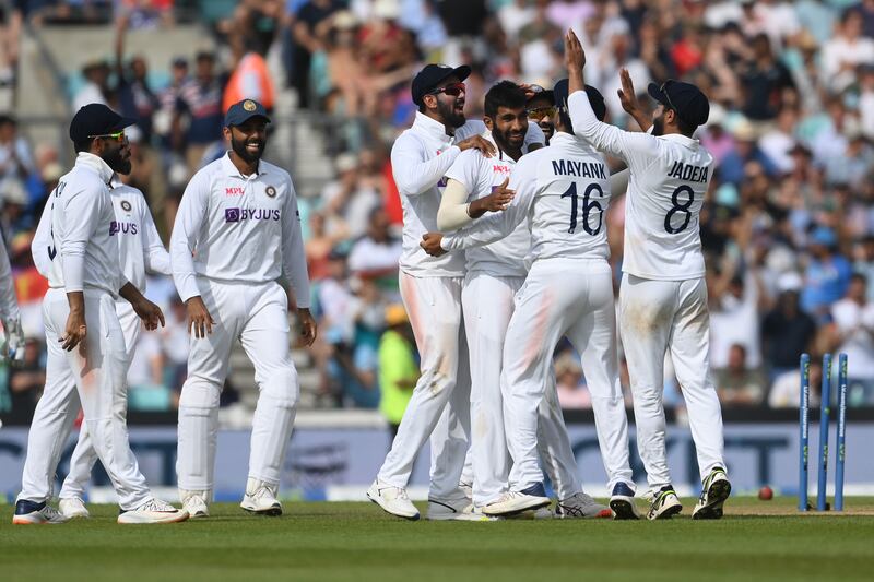 India bowler Jasprit Bumrah is mobbed by teammates after claiming the wicket of Jonny Bairstow. Getty