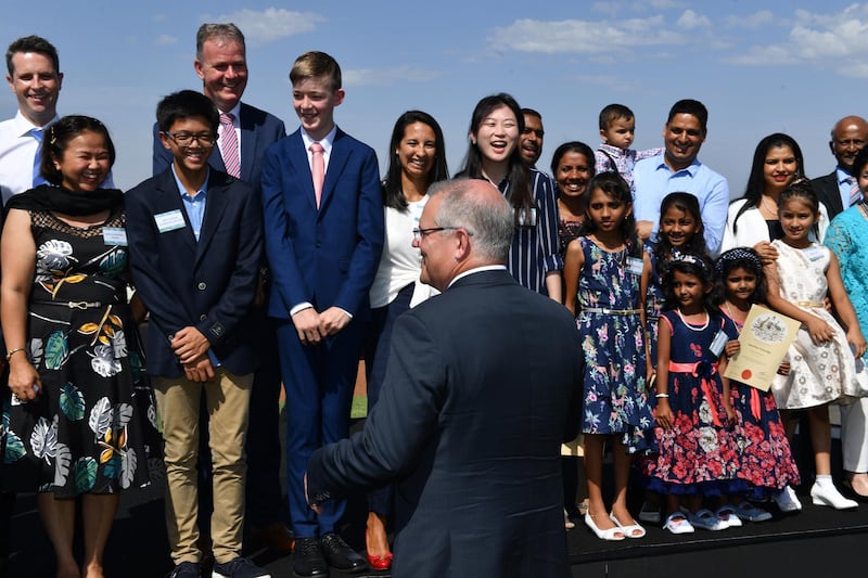 Prime Minister Scott Morrison speaks with newly sworn citizens during Australia Day Citizenship Ceremony in Canberra.  EPA