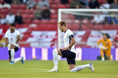 Soccer Football - International Friendly - England v Austria - Riverside Stadium, Middlesbrough, Britain - June 2, 2021 England's Harry Kane kneels in support of the Black Lives Matter campaign before the match Pool via REUTERS/Peter Powell