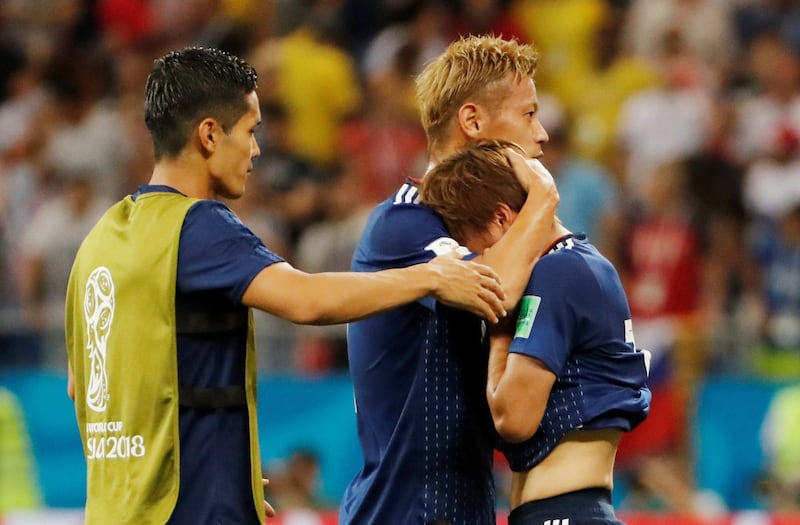 Soccer Football - World Cup - Round of 16 - Belgium vs Japan - Rostov Arena, Rostov-on-Don, Russia - July 2, 2018  Japan's Takashi Inui is consoled by teammate Keisuke Honda after the match   REUTERS/Jorge Silva