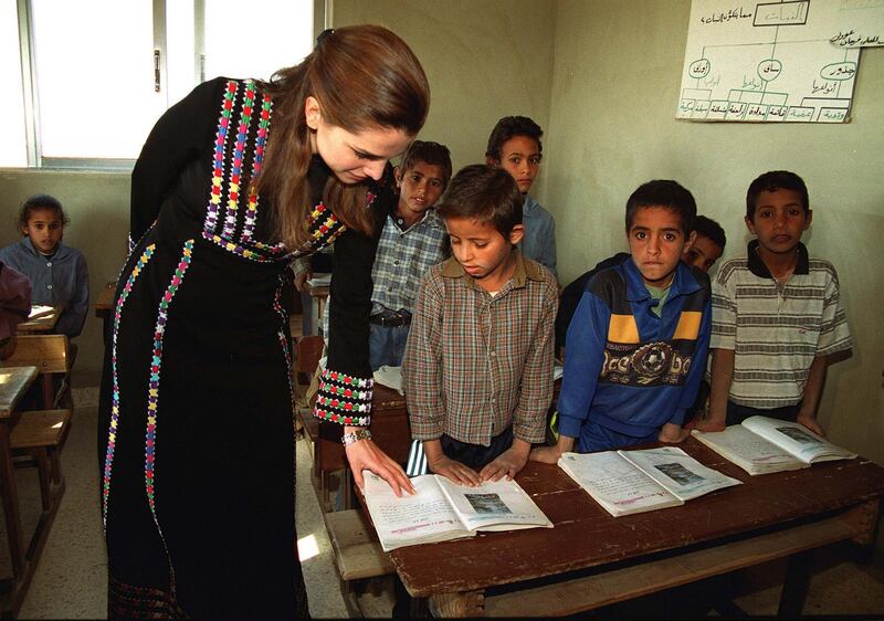383497 01: Queen Rania of Jordan talks to a child in a schoolroom December 17, 2000 in Kerak, south of Amman, Jordan. Rania contributed donations for the needy families in the holy Muslim fasting month of Ramadan. (Photo by Salah Malkawi/Newsmakers)