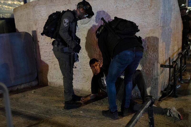 Israeli police detain a Palestinian youth at the Damascus Gate to the Old City of Jerusalem after clashes near Al Aqsa Mosque on Friday, May 7, 2021. AP