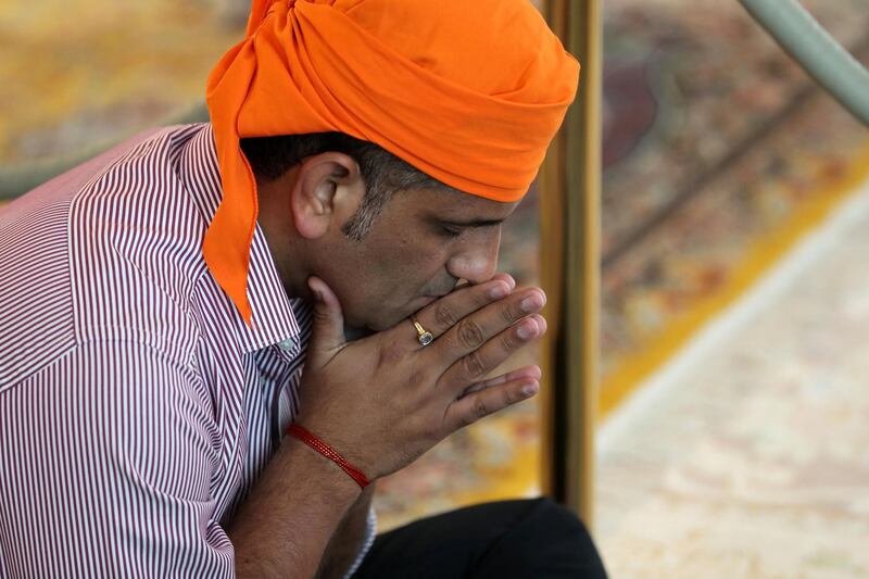 Dubai, United Arab Emirates - May 15, 2019: Members of the congregation pray. People take part in a multi faith Iftar at Gurunanak Darbar Sikh Gurudwara. Wednesday the 15th of May 2019. Jebel Ali, Dubai. Chris Whiteoak / The National