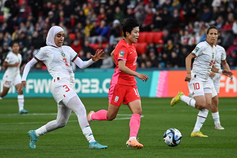 Morocco defender Nouhaila Benzina, left, tackles South Korea forward Ji So-yun.  AFP