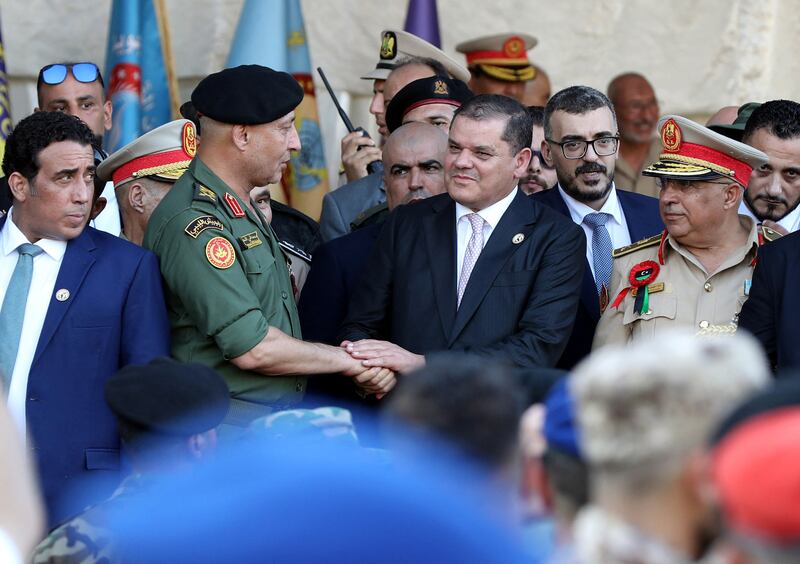 Lt Gen Mohamed al-Haddad greets Libya's Prime Minister Abdulhamid Dbeibah, head of the unity government in Tripoli, at the parade.  