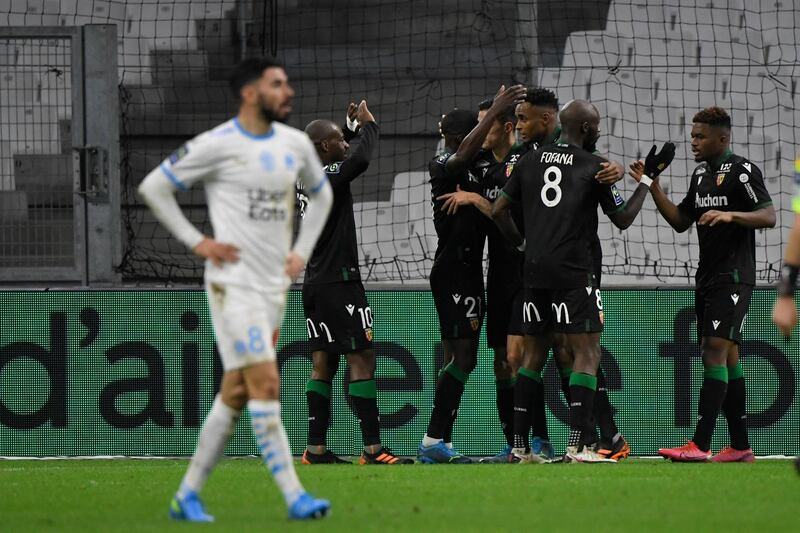 Lens' players celebrate after Simon Banza scored their second-half winner at Marseille. AFP